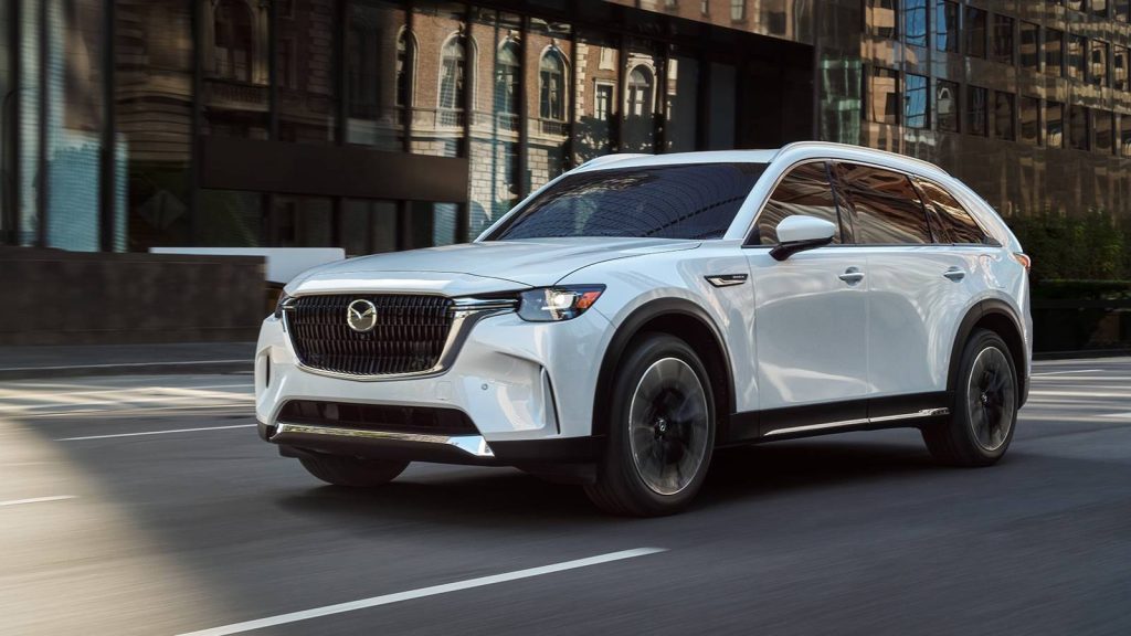2026 Mazda CX-90 white SUV driving on city street