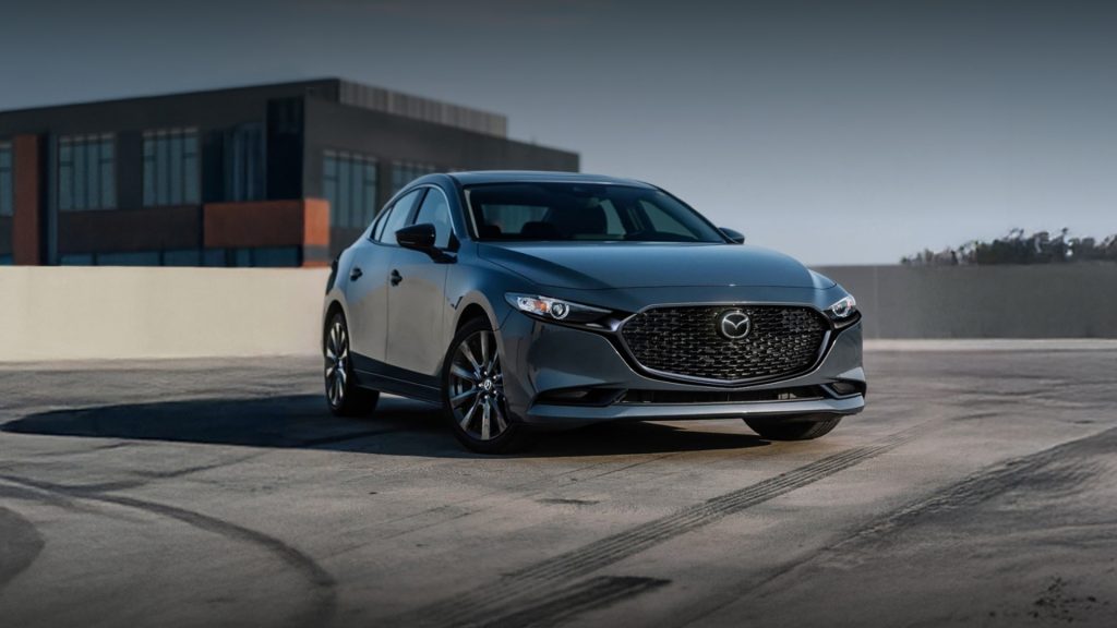 2026 Mazda3 Sedan parked on a rooftop, highlighting its sleek design and modern styling.